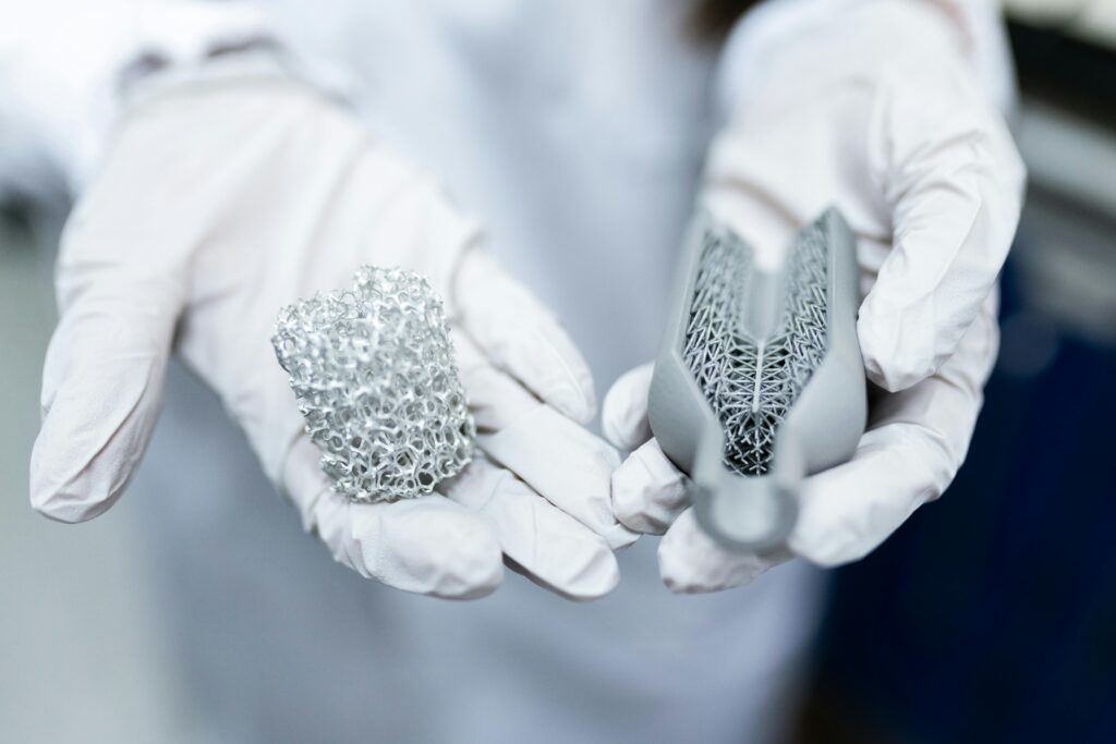 pexels photo 3861437 3861437 Laboratory setting showing gloved hands holding innovative 3D printed metal structures.